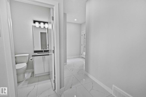 Bathroom featuring vanity, light marble finish floors, and recessed lighting - 3524 41 Ave, Beaumont, AB - Indoor Photo Showing Bathroom