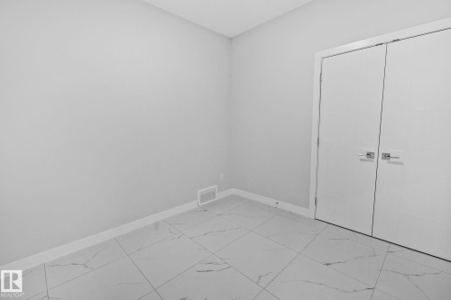 Unfurnished bedroom featuring light marble finish floors and a closet - 3524 41 Ave, Beaumont, AB - Indoor Photo Showing Other Room