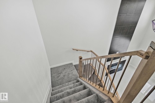 Staircase with baseboards - 3524 41 Ave, Beaumont, AB - Indoor Photo Showing Other Room