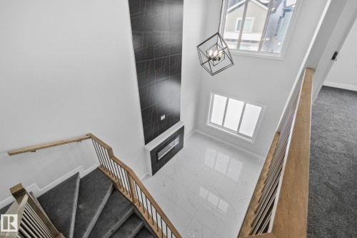 Staircase featuring a high ceiling and hanging lights - 3524 41 Ave, Beaumont, AB - Indoor Photo Showing Other Room