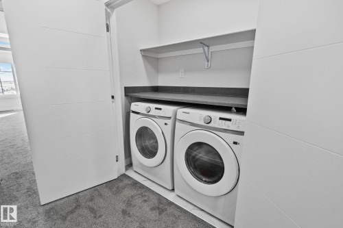 Laundry area with separate washer and dryer and dark colored carpet - 3524 41 Ave, Beaumont, AB - Indoor Photo Showing Laundry Room