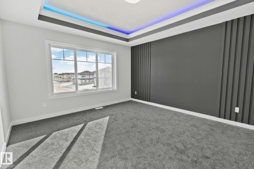 Unfurnished room featuring carpet floors and a raised ceiling - 3524 41 Ave, Beaumont, AB - Indoor Photo Showing Other Room