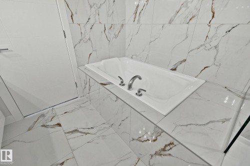 Full bathroom with a bath and marble finish flooring - 3524 41 Ave, Beaumont, AB - Indoor Photo Showing Bathroom