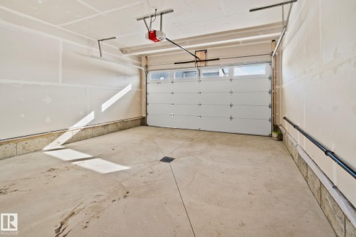 Garage featuring a garage door opener - 3524 41 Ave, Beaumont, AB - Indoor Photo Showing Garage