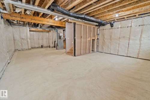 Unfinished basement featuring heating unit and stairway - 3524 41 Ave, Beaumont, AB - Indoor Photo Showing Basement