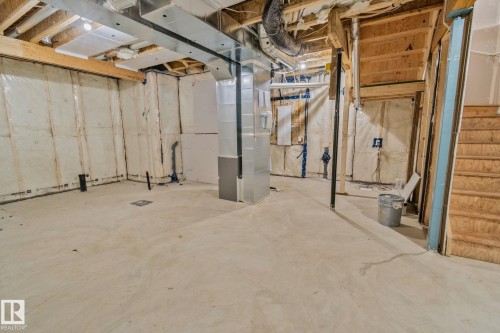 Unfinished below grade area with heating unit and stairway - 3524 41 Ave, Beaumont, AB - Indoor Photo Showing Basement
