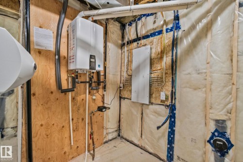 Utility room with electric panel and water heater - 3524 41 Ave, Beaumont, AB - Indoor Photo Showing Basement