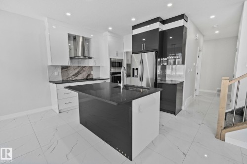 Kitchen featuring modern cabinets, dark stone counters, stainless steel appliances, and recessed lighting - 3524 41 Ave, Beaumont, AB - Indoor Photo Showing Kitchen With Stainless Steel Kitchen With Upgraded Kitchen