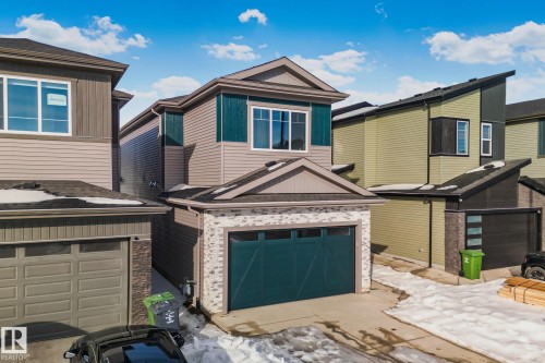 View of front facade featuring brick siding and an attached garage - 3524 41 Ave, Beaumont, AB - Outdoor With Exterior