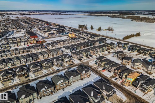 Aerial view of property and surrounding area with nearby suburban area - 3524 41 Ave, Beaumont, AB - Outdoor With Body Of Water With View