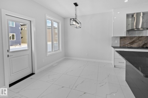 Unfurnished dining area featuring light marble finish floors - 3524 41 Ave, Beaumont, AB - Indoor