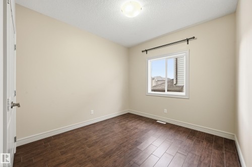 Unfurnished room with dark wood finished floors and a textured ceiling - 1346 Cunningham Drive W, Edmonton, AB - Indoor Photo Showing Other Room