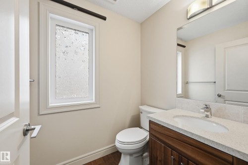 Half bathroom with vanity and dark wood finished floors - 1346 Cunningham Drive W, Edmonton, AB - Indoor Photo Showing Bathroom