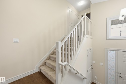 Staircase featuring baseboards and wood finished floors - 1346 Cunningham Drive W, Edmonton, AB - Indoor Photo Showing Other Room