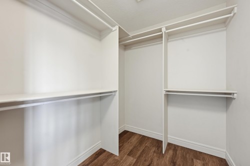 Walk in closet featuring dark wood-style flooring - 1346 Cunningham Drive W, Edmonton, AB - Indoor With Storage