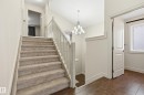 Stairway with wood-type flooring and suspended lighting - 1346 Cunningham Drive W, Edmonton, AB  - Indoor Photo Showing Other Room 