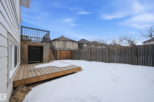 Fenced backyard with a residential view and a wooden deck - 1346 Cunningham Drive W, Edmonton, AB - Outdoor With Exterior