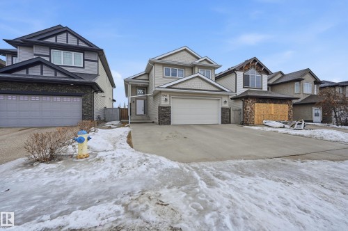 Craftsman-style home featuring stone siding and driveway - 1346 Cunningham Drive W, Edmonton, AB - Outdoor With Facade