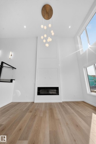 211 Paterson Link Link, Edmonton, AB - Indoor Photo Showing Other Room With Fireplace