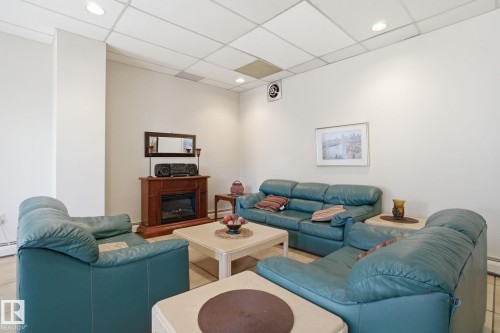1105 8340 Jasper Avenue, Edmonton, AB - Indoor Photo Showing Living Room With Fireplace