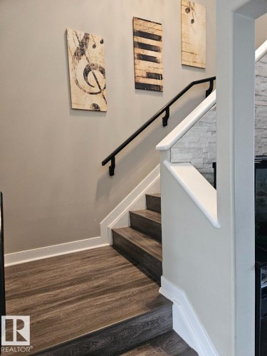 Staircase featuring baseboards - 208 Kirpatrick Way, Leduc, AB - Indoor Photo Showing Other Room
