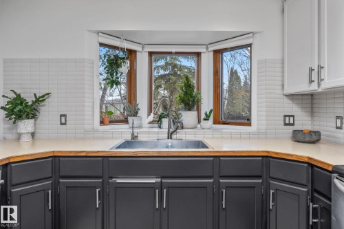 Kitchen with light countertops, gray cabinets, and tasteful backsplash - 175 Roy Street, Edmonton, AB - Indoor Photo Showing Kitchen With Double Sink