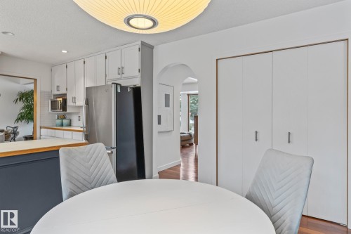 Dining space with arched walkways, dark wood-style flooring, recessed lighting, and a textured ceiling - 175 Roy Street, Edmonton, AB - Indoor Photo Showing Other Room