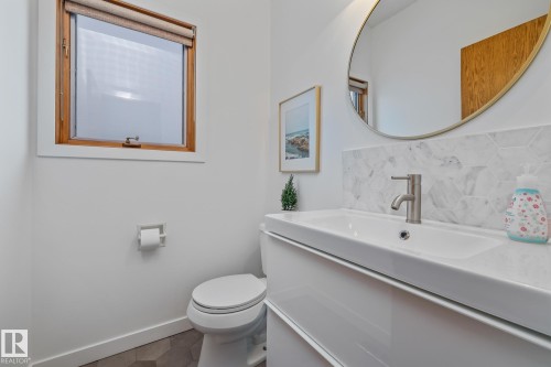 Bathroom featuring backsplash, vanity, and tile patterned flooring - 175 Roy Street, Edmonton, AB - Indoor Photo Showing Bathroom