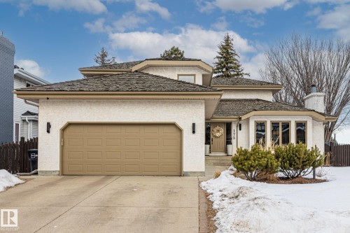 View of front of house with an attached garage, driveway, stucco siding, and a chimney - 175 Roy Street, Edmonton, AB - Outdoor