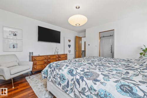 Bedroom featuring dark wood-style floors and ensuite bathroom - 175 Roy Street, Edmonton, AB - Indoor Photo Showing Bedroom