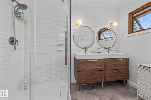 Bathroom featuring double vanity, a stall shower, and light tile patterned floors - 175 Roy Street, Edmonton, AB - Indoor Photo Showing Bathroom