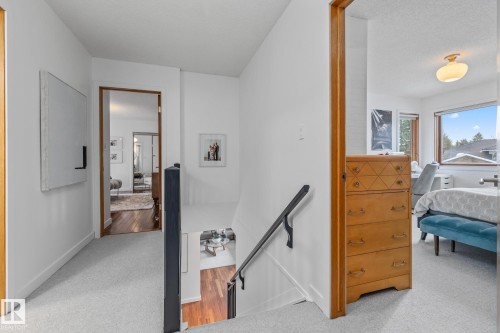Corridor with an upstairs landing, light carpet, and a textured ceiling - 175 Roy Street, Edmonton, AB - Indoor Photo Showing Bedroom