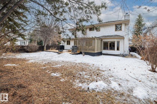 Snow covered rear of property with a fenced backyard, a chimney, a patio, and a shingled roof - 175 Roy Street, Edmonton, AB - Outdoor