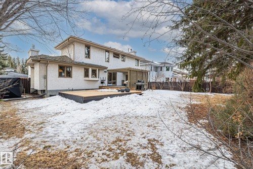 Snow covered back of property with a chimney and a deck - 175 Roy Street, Edmonton, AB - Outdoor With Deck Patio Veranda