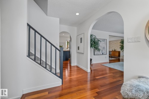 Foyer entrance with wood finished floors, a textured ceiling, arched walkways, and recessed lighting - 175 Roy Street, Edmonton, AB - Indoor Photo Showing Other Room