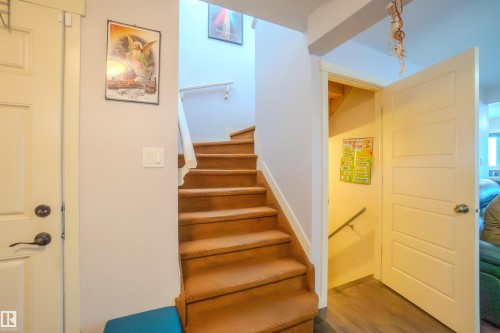 Stairs with wood finished floors and baseboards - 5244 1A Avenue Sw, Edmonton, AB - Indoor Photo Showing Other Room
