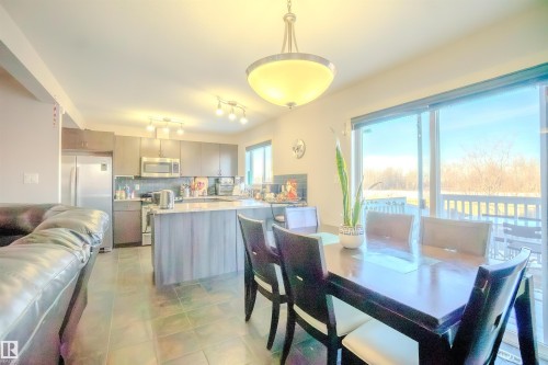 Dining space with light tile patterned flooring - 5244 1A Avenue Sw, Edmonton, AB - Indoor