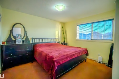 Carpeted bedroom with baseboards - 5244 1A Avenue Sw, Edmonton, AB - Indoor Photo Showing Bedroom