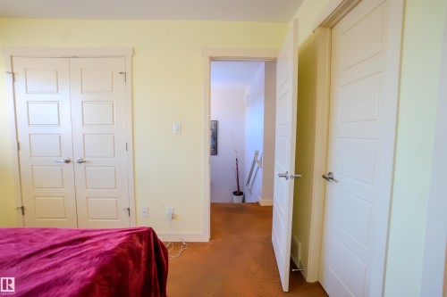 Carpeted bedroom featuring a closet and baseboards - 5244 1A Avenue Sw, Edmonton, AB - Indoor Photo Showing Bedroom