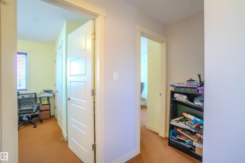 Corridor with light carpet and a desk - 5244 1A Avenue Sw, Edmonton, AB - Indoor