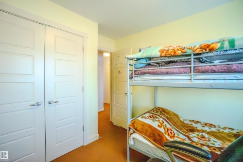 Carpeted bedroom with a closet - 5244 1A Avenue Sw, Edmonton, AB - Indoor Photo Showing Other Room