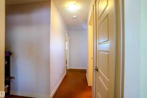 Hall with baseboards and dark carpet - 5244 1A Avenue Sw, Edmonton, AB - Indoor Photo Showing Other Room