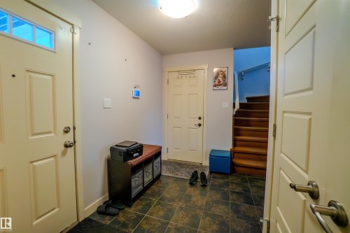 Foyer featuring stairway and baseboards - 5244 1A Avenue Sw, Edmonton, AB - Indoor Photo Showing Other Room