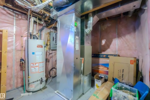Utility room with gas water heater and heating unit - 5244 1A Avenue Sw, Edmonton, AB - Indoor Photo Showing Basement