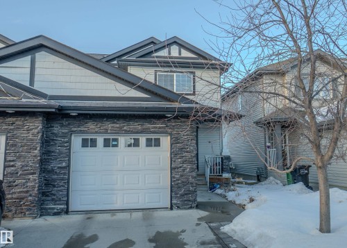 Craftsman-style house featuring stone siding and an attached garage - 5244 1A Avenue Sw, Edmonton, AB - Outdoor