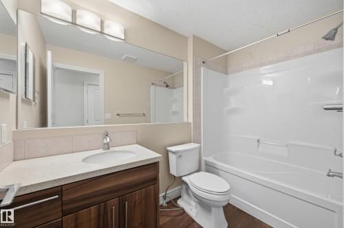 Bathroom featuring vanity, shower / bathtub combination, and dark wood finished floors - 1349 Cunningham Drive, Edmonton, AB - Indoor Photo Showing Bathroom