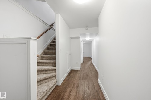 Corridor featuring stairs and dark wood-type flooring - 1349 Cunningham Drive, Edmonton, AB - Indoor Photo Showing Other Room