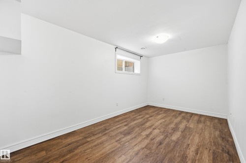 Spare room featuring baseboards and dark wood finished floors - 1349 Cunningham Drive, Edmonton, AB - Indoor Photo Showing Other Room