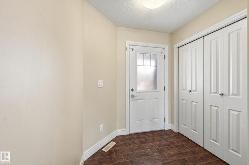 Doorway with a textured ceiling and wood finish floors - 1349 Cunningham Drive, Edmonton, AB - Indoor Photo Showing Other Room
