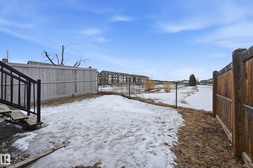 Yard layered in snow featuring a fenced backyard - 1349 Cunningham Drive, Edmonton, AB - Outdoor